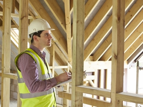 Construction builder taking measurements